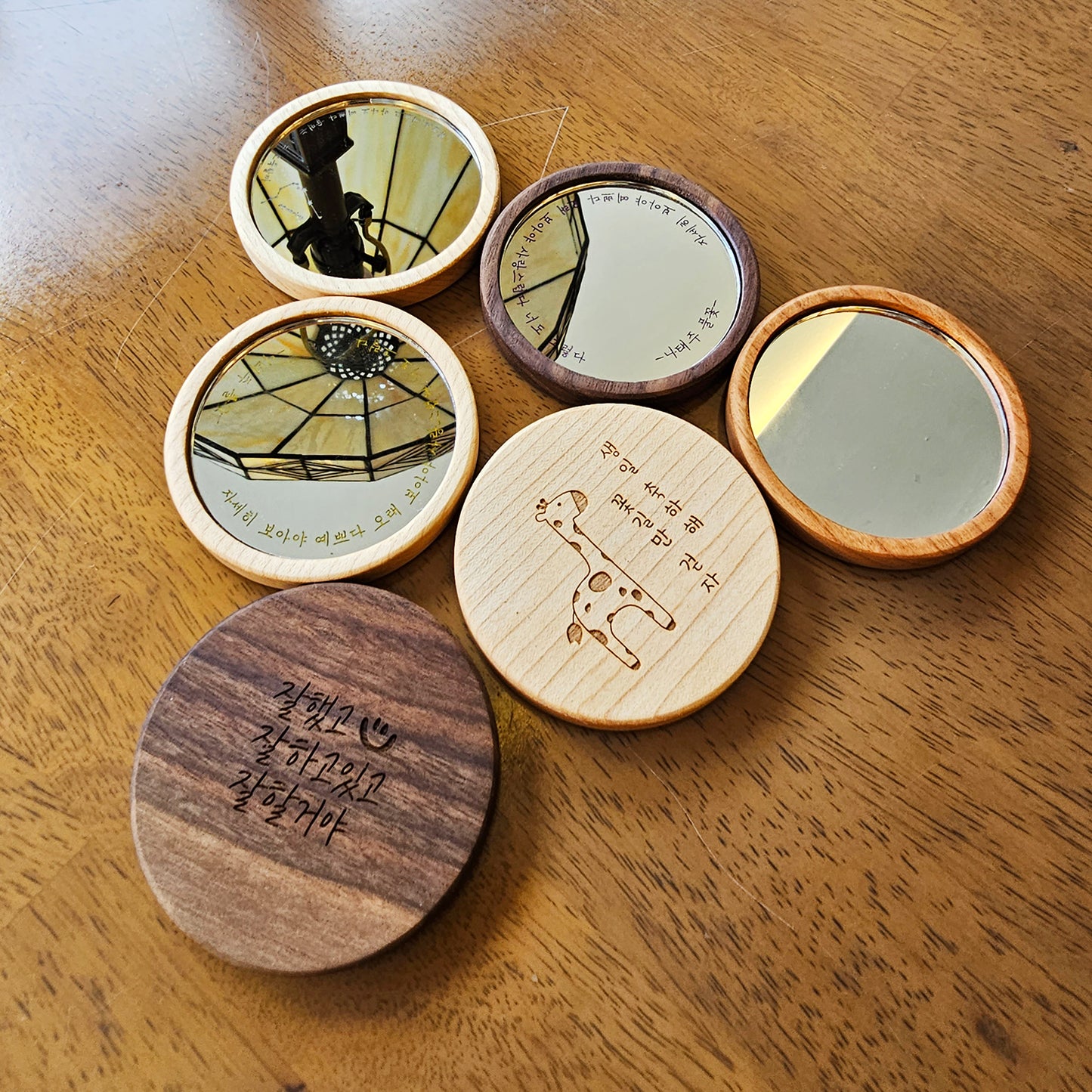 Atelier Hangeul handmade wooden hand mirror with Korean text and drawing